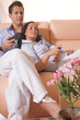 Young couple watching tv on the couch