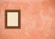 Grunge pink stucco wall with empty picture frame