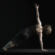 Foto: Rear view of woman balanced on arm in yoga position Rear view of woman balanced on arm in yoga position