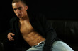 Muscular young man on a couch