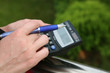 Hand with pen and calculator