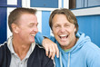 Two happy gay men cuddling. Two happy gay men cuddling.