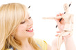 happy teenage girl with wooden model dummy
