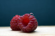 Fresh and tasty raspberries on the blue background