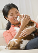 Woman Cuddling Dog