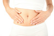 Photo: Closeup of young woman with hands on her stomach Closeup of young woman with hands on her stomach