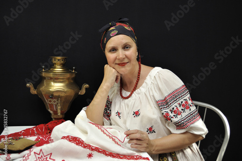 Photo: Lady embroiderer in traditional Ukrainian clothes on black Lady embroiderer in traditional Ukrainian clothes on black