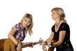 Mother and her teen daughter playing guitar Mother and her teen daughter playing guitar