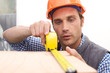 Laborer working with measuring tape