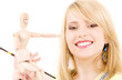 happy teenage girl with wooden model dummy