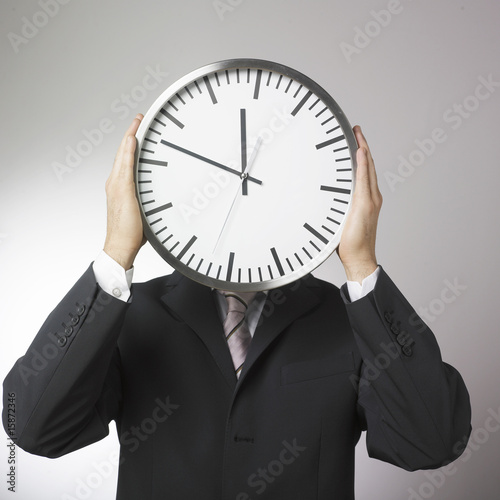 Photo: visage d'homme d'affaires horloge visage d'homme d'affaires horloge