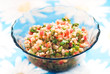 Photo: Tabouli middle eastern salad at glass bowl over floral napkin Tabouli middle eastern salad at glass bowl over floral napkin