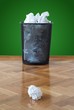 Wastepaper bin full of crumpled paper balls one on floor Wastepaper bin full of crumpled paper balls one on floor