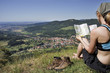 femal hiker with hiking boots and map