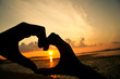 Heart fingers love concept at sunset Heart fingers love concept at sunset