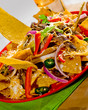 Tortilla chips with beef and vegetables on the plate Tortilla chips with beef and vegetables on the plate