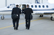 Businessmen walking toward corporate jet