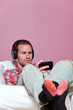 Man in casual clothing sat listening to music