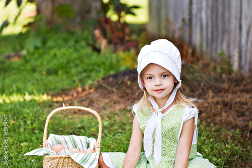 Photo: Little Amish girl gathering eggs Little Amish girl gathering eggs