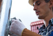 Man installing rain gutter system