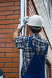 Man installing  rain gutter system