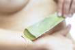Woman applying aloe vera gel
