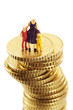 Figurines, mother and childeren, on pile of coins