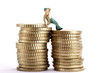 Figurine leaning on pile of coins, holding hat
