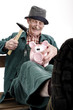 Man breaking piggy bank, close-up, smiling