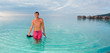 man with snorkel gear in turquoise waters