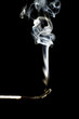 Burnt matchstick on black background, close-up