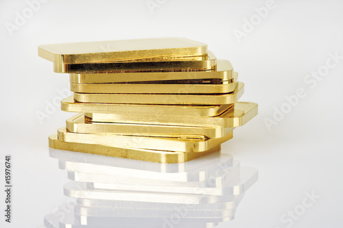 Photo: Gold bars on white background Gold bars on white background