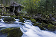 Austria, Golling, Waterfall overlooked by small wooden watermill.