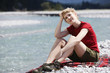 Germany, Bavaria, Tölzer Land, Young woman on river bank