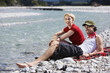 Germany, Bavaria, Tölzer Land, Young couple sitting on riverbank