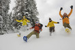 Italy, South Tyrol, People with snowshoes fooling about