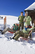 Photo: Italy, South Tyrol, Seiseralm, Persons in front of log cabin, holding champagne glasses Italy, South Tyrol, Seiseralm, Persons in front of log cabin, holding champagne glasses