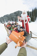 Photo: Italy, South Tyrol, Seiseralm, Santa Claus and children, children holding gift parcels Italy, South Tyrol, Seiseralm, Santa Claus and children, children holding gift parcels