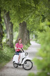 Germany, Bavaria, Young man on moped, smiling, portrait