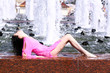 Photo: young woman bathes in a city fountain young woman bathes in a city fountain