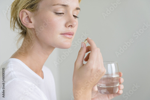 Photo: Woman taking an Omega-3 capsule Woman taking an Omega-3 capsule