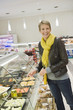Woman choosing food in a supermarket