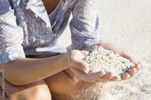 Photo: Woman playing with sand on the beach Woman playing with sand on the beach