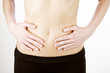 A young woman touching her stomach