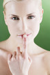 A young woman touching her lips