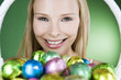 A young blonde woman holding a basket of Easter eggs, smiling