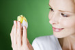 A woman looking at an Easter chick toy