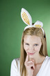 A young blonde woman wearing rabbit ears