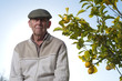 Sad senior man next to lemon tree