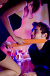 Funny scene of young happy playfully couple at celebration